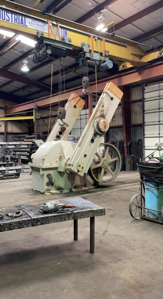 Gear box being hoisted inside a repair shop