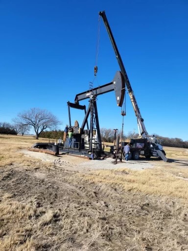 A pumping unit being installed via a crane